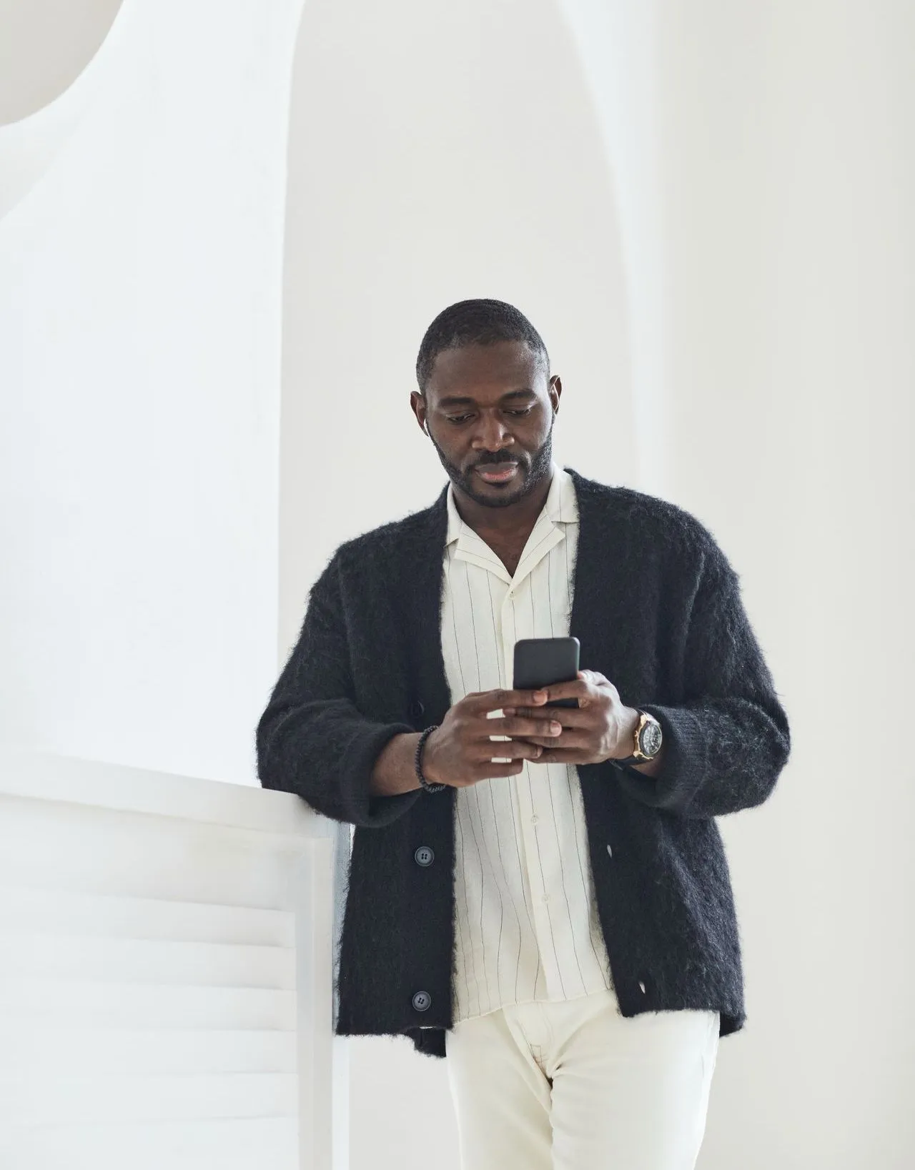 A man smiling at his phone